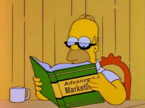 This is an image of Homer Simpson reading a book about advanced marketing.