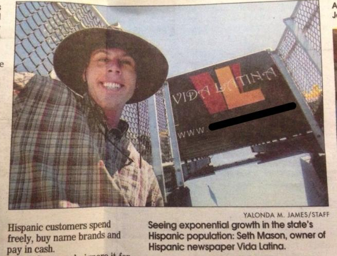 This is an image of Seth Mason standing under a Vida Latina sign, wearing a wide-brimmed hat. It's from an interview with the Post and Courier (Charleston, SC).
